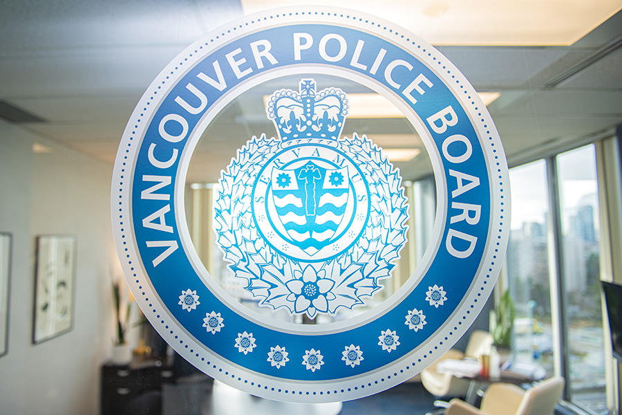Vancouver Police Board logo on a glass door
